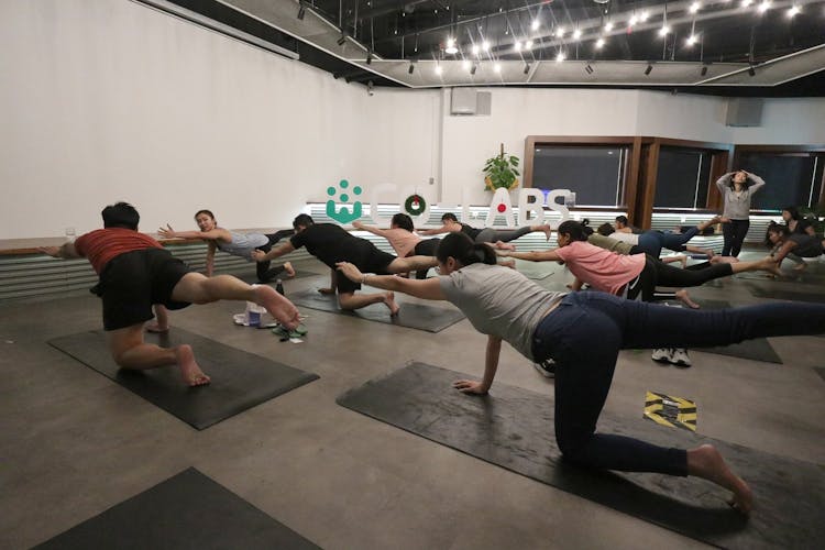 A group of people practicing yoga at Co-labs Coworking The Starling